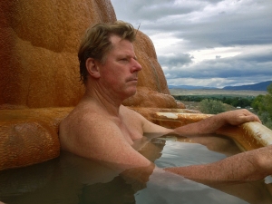 Chris relaxing in an old claw-foot type tub with hot water trickling  down from natural springs. The tub is gradually being encased by the layers of mineral deposits. I was also sitting in the tub when I took thus photo. 